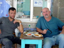 Matt Barret and Spiro Cooper eating Sardeles Pastes at Aglaia's in  Xidera, Lesvos